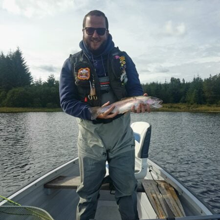 A fine perfect rainbow trout caught on a fly shop hopper